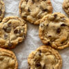lightly browned chocolate chip cookies on parchment paper