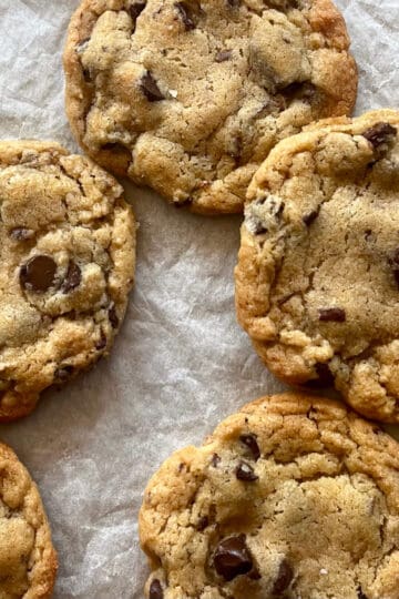 lightly browned chocolate chip cookies on parchment paper